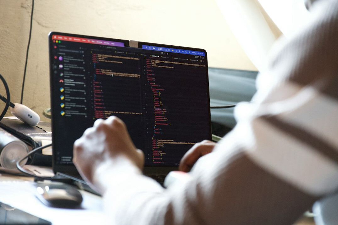 person reviewing code on monitor