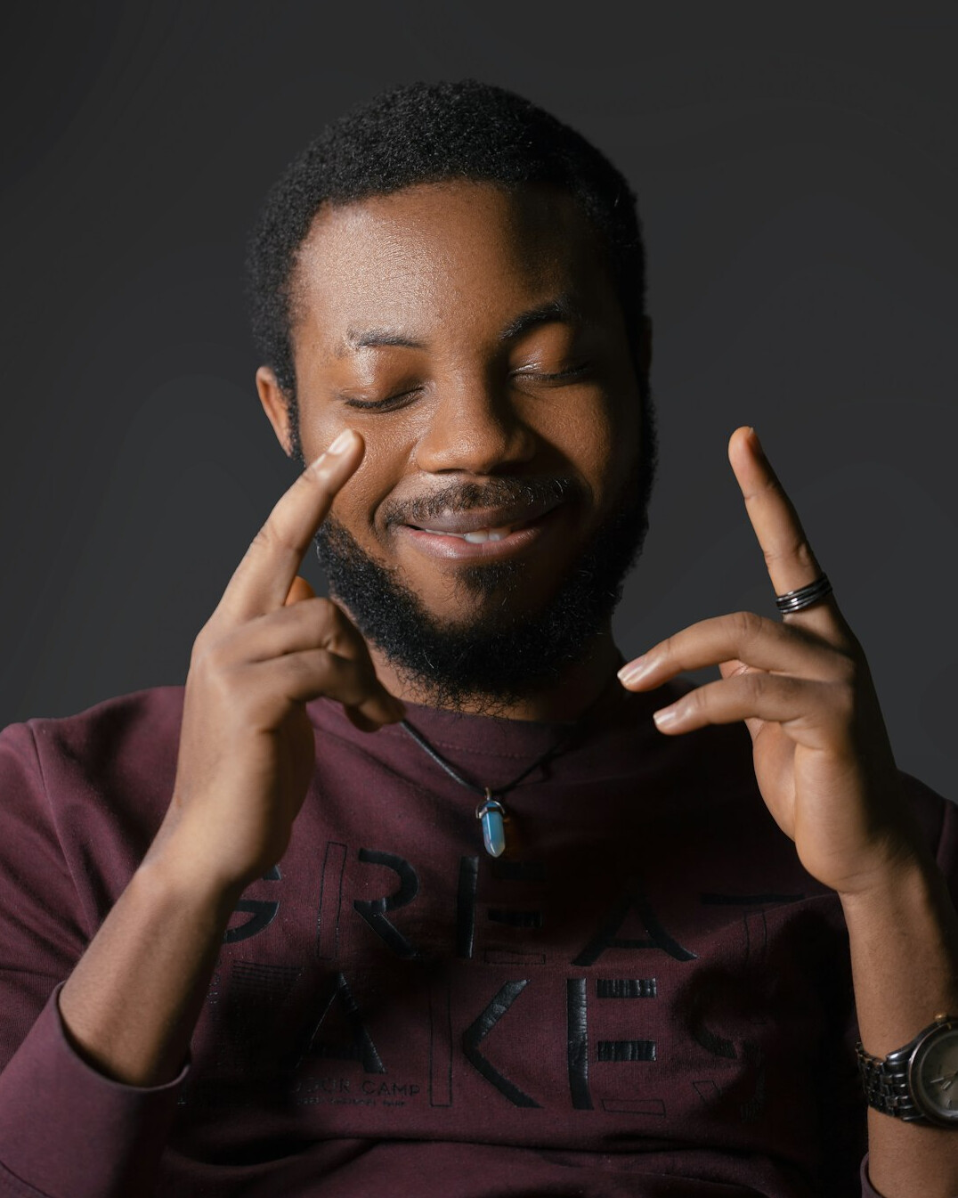 Studio portrait of a smiling man with short beard