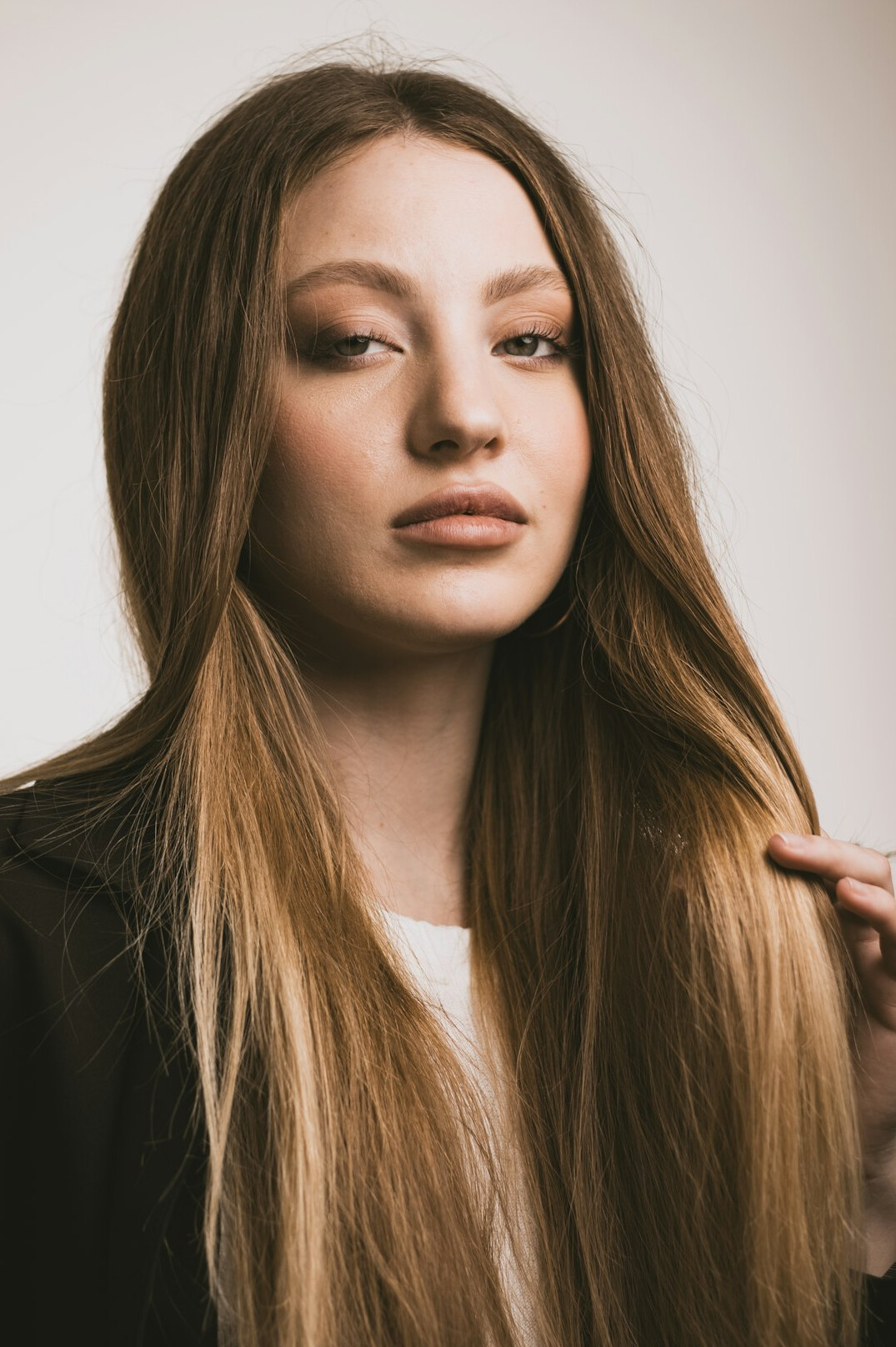 Studio portrait of a smiling woman with long hair